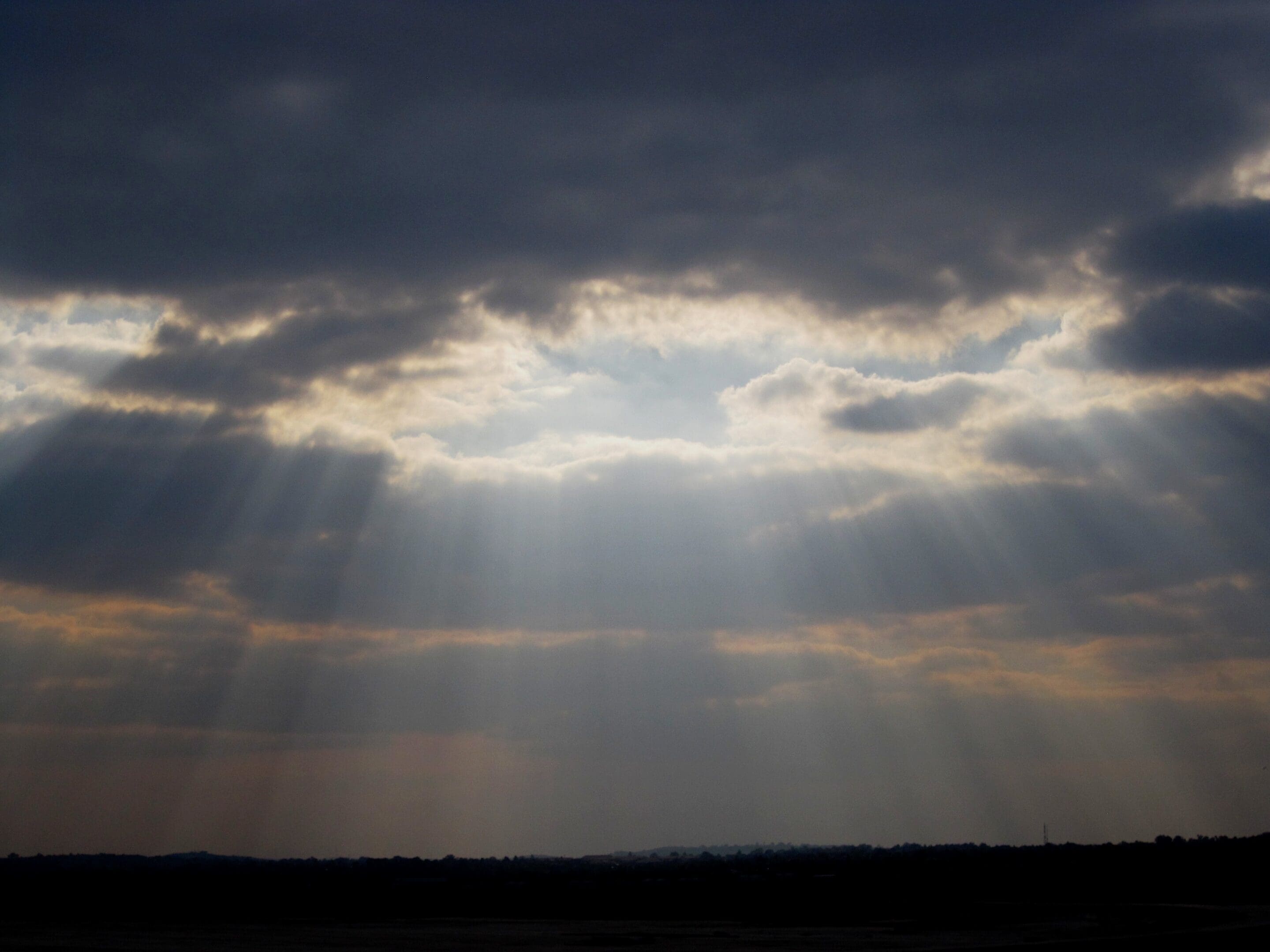 Sunlight breaking through clouds — a visual of grace defined, the smile of God breaking into our lives.