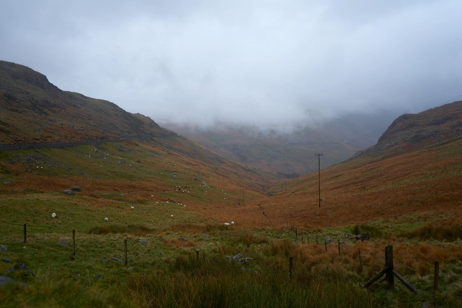 A misty Welsh valley between mountain ridges, evoking the lonely road where Christmas Evans climbed the mountainside to wrestle in prayer and got his fire back.