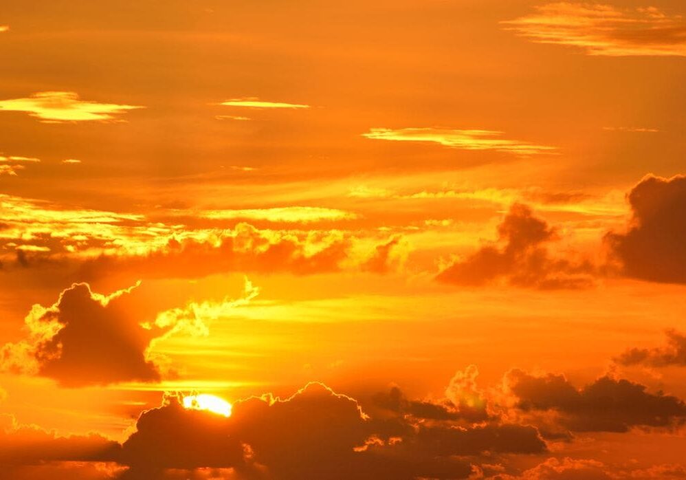 Dramatic sun rays burst through clouds at golden hour — the second birth, being made new from the inside