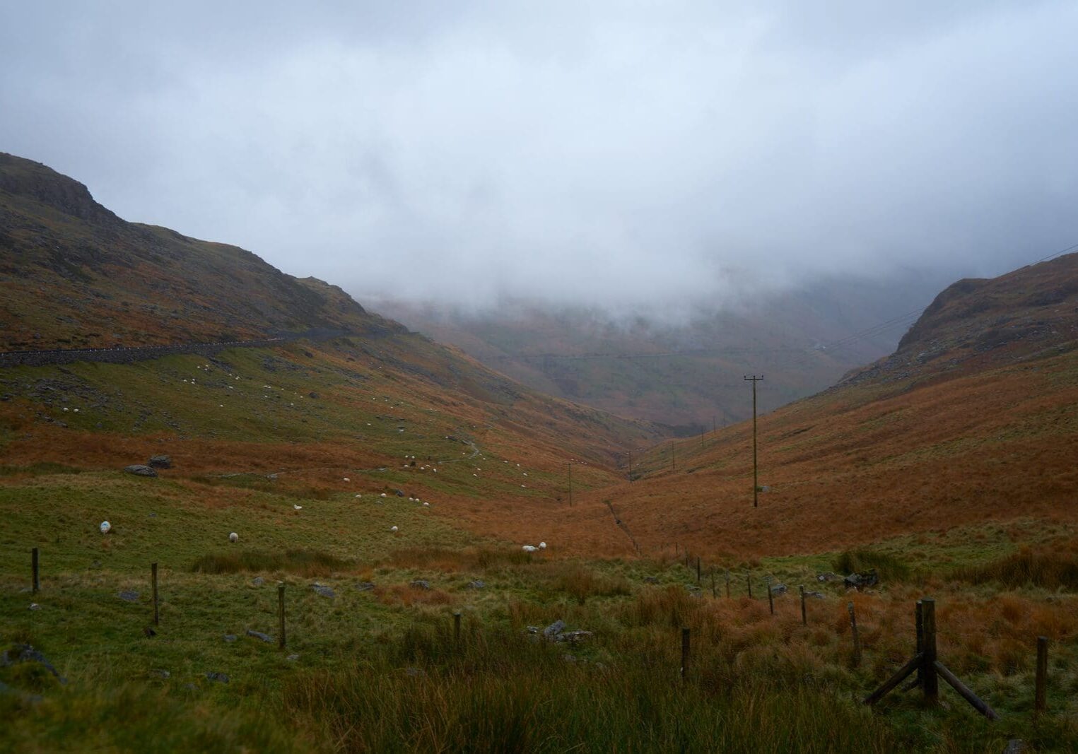 A misty Welsh valley between mountain ridges, evoking the lonely road where Christmas Evans climbed the mountainside to wrestle in prayer and got his fire back.