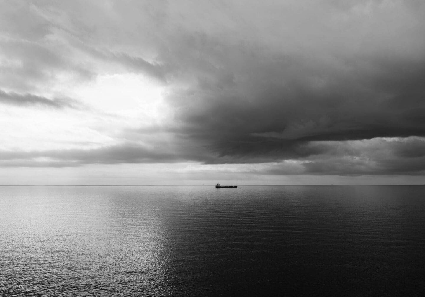 A solitary ship crossing a stormy sea at dawn, a picture of faith holding steady through suffering
